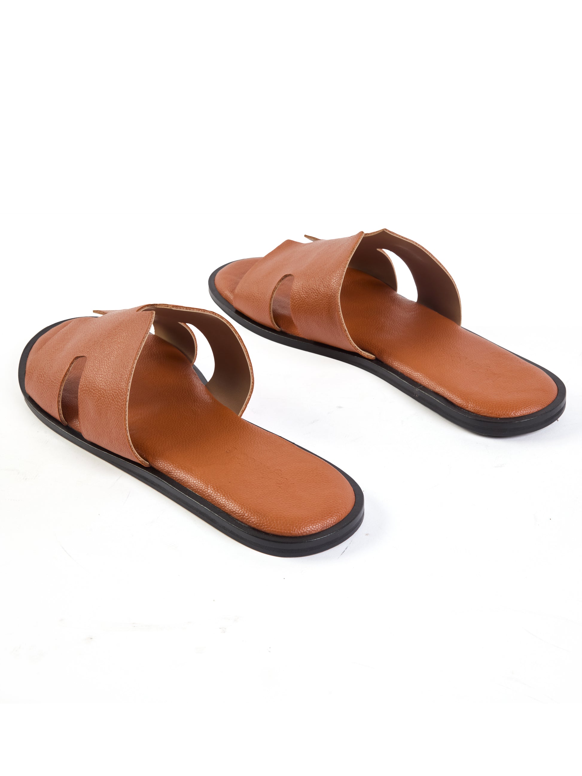 Pair of brown sandals with black soles on a white background